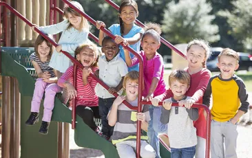 Group of diverse elementary students on playground