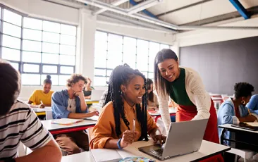 High school teacher and student working together