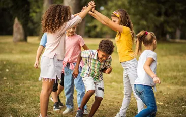 Young children playing happily outside