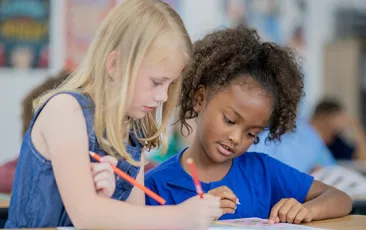 Two elementary students working together