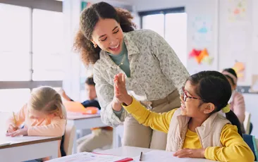 Teacher high fiving student