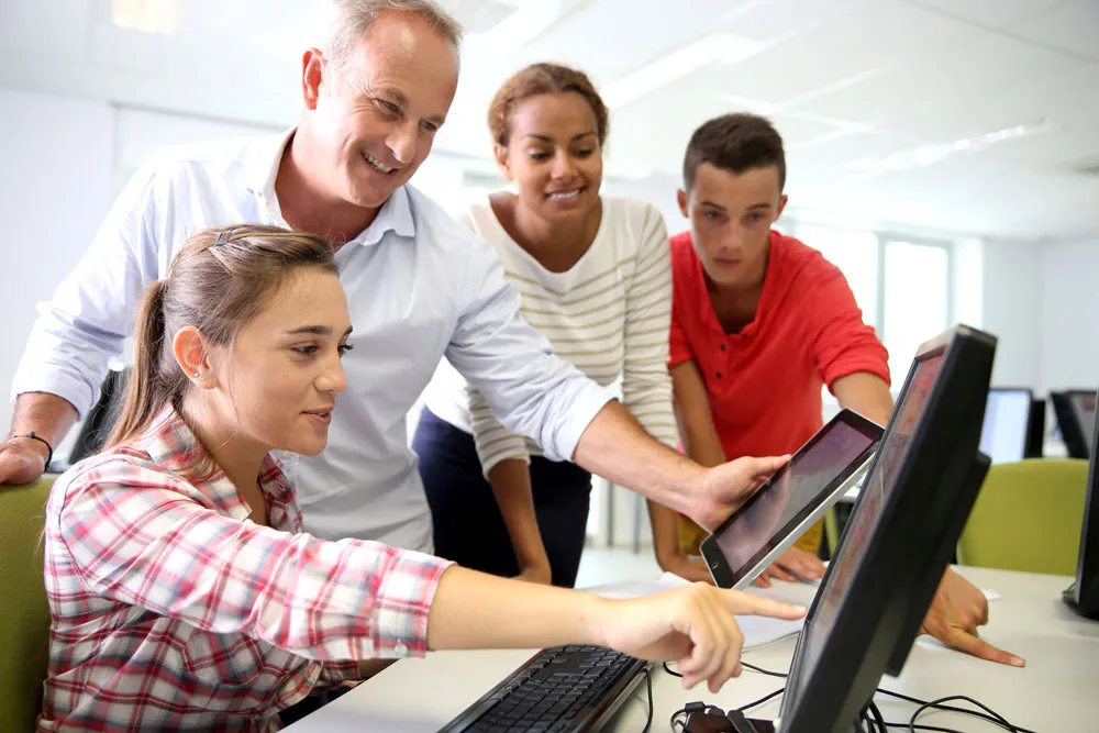 Teacher with students in computer lab