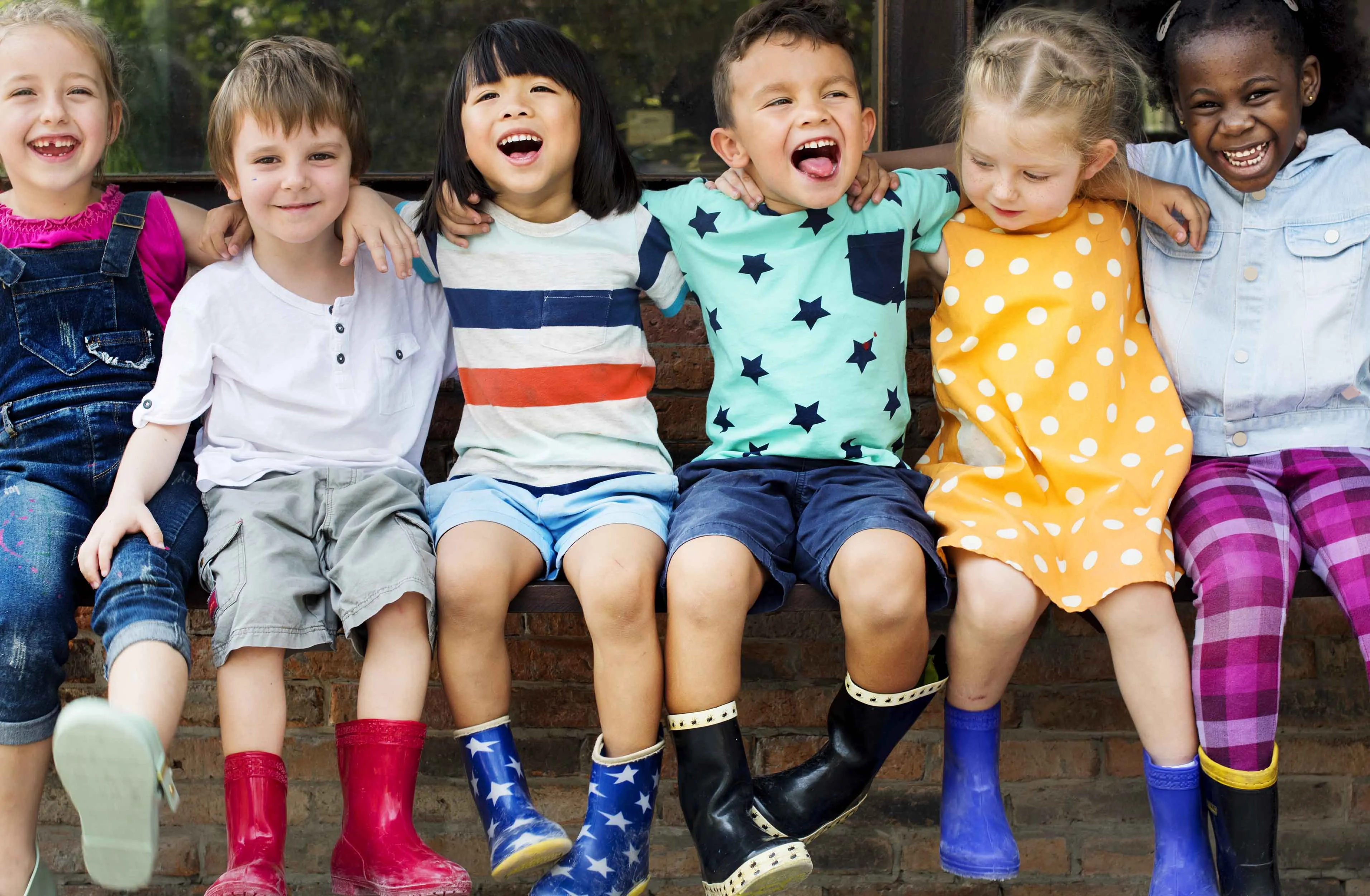Children arm in arm singing