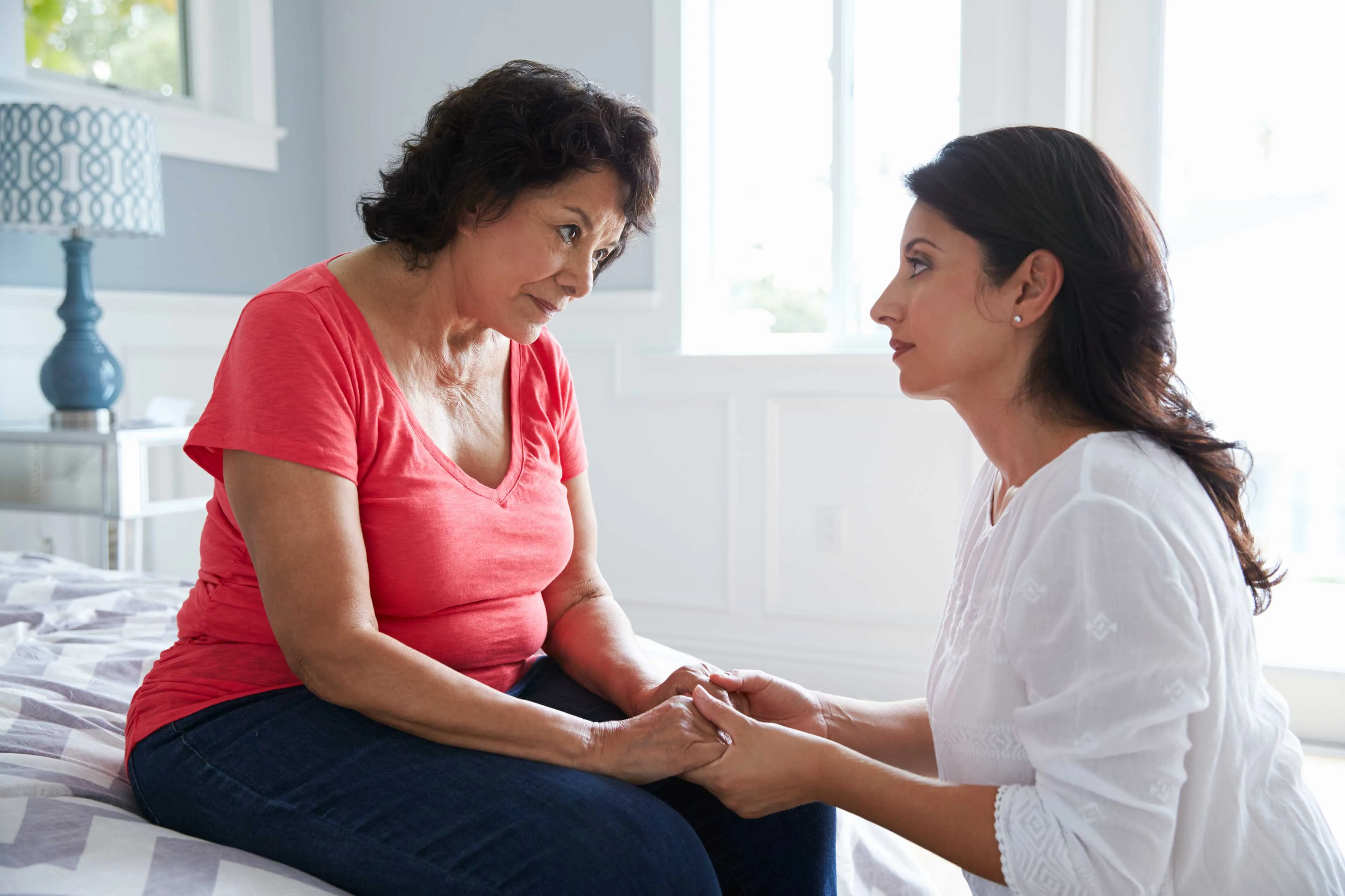 Woman with brain injury and daughter holding hands