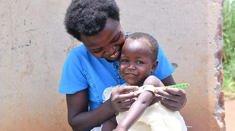 Boy having arm measured in Uganda