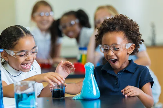 elementary kids doing a science experiment