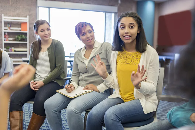 teen girl talking in a group meeting