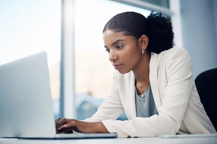 woman at work looking thoughtfully at computer