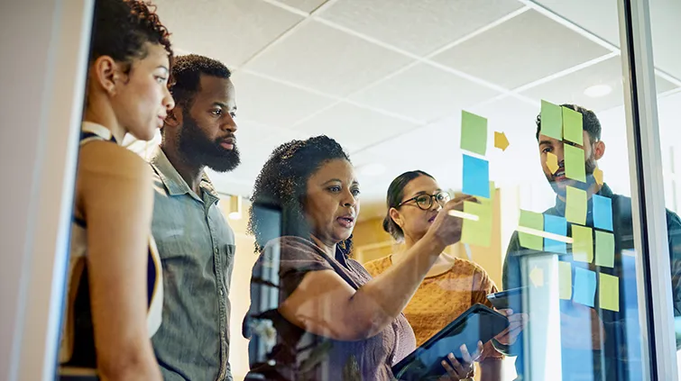 Business colleagues at a glass board