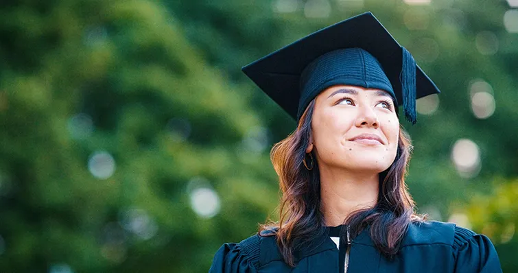 Young female college student in cap and gown