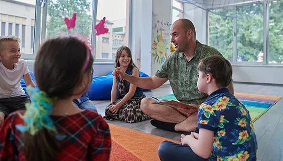 Preschool teacher with young students