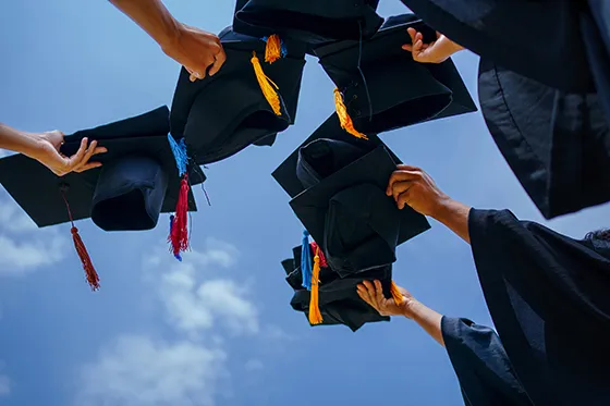 Graduation caps in the air