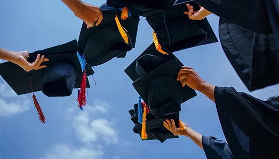 Graduation caps in the air