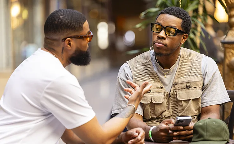 African American men talking at a cafe