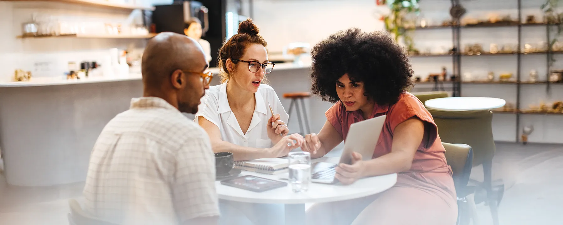 Colleagues working together at small table