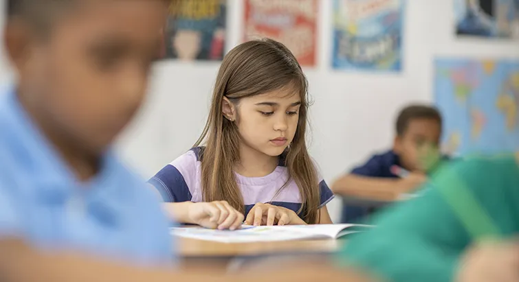Elementary student reading in class