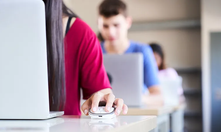 Female student clicking a mouse