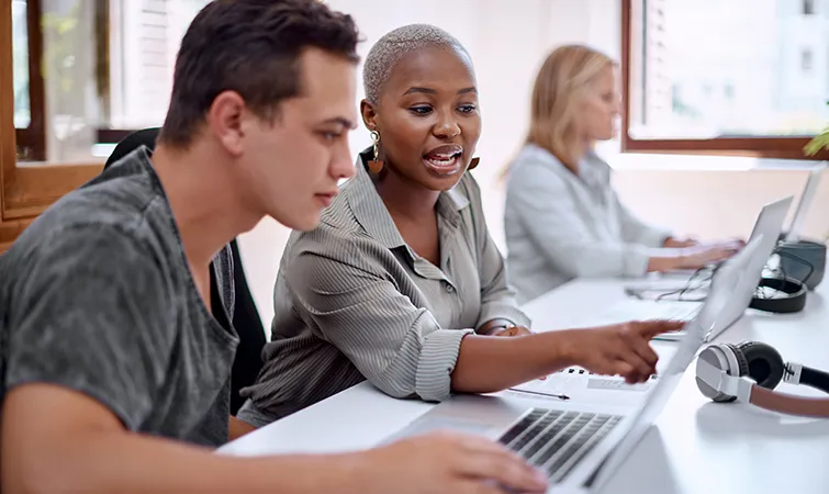 Community college student and teacher at computer