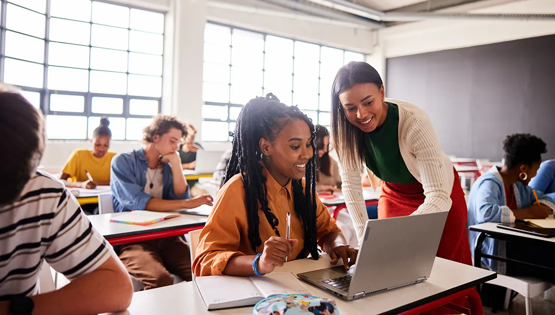 High school teacher and student working together