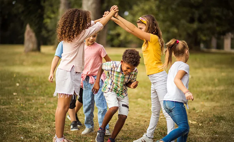 Young children playing happily outside