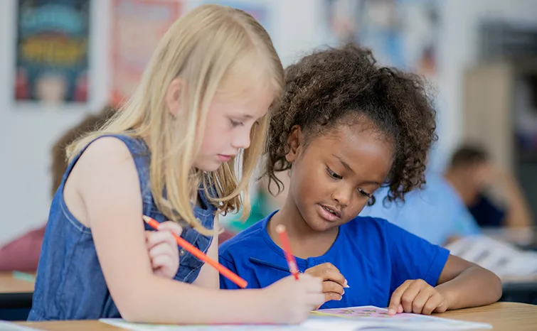 Two elementary students working together