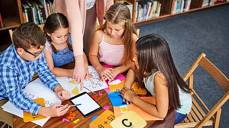 Elementary students working with math flash cards