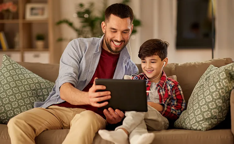 Father and son looking at iPad together