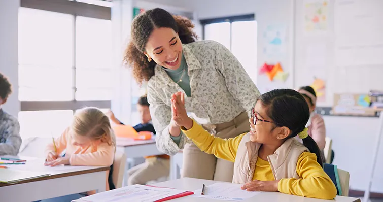 Teacher high fiving student