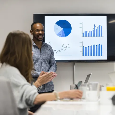 Person presenting in a conference room