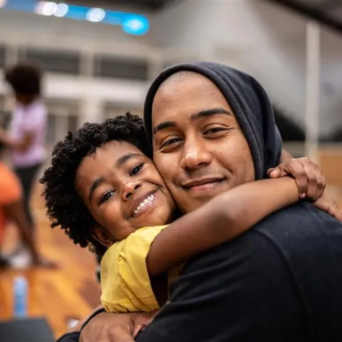 Father and daughter embracing at community center