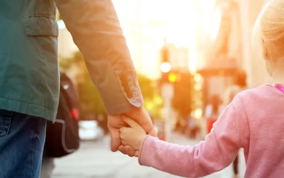 Child and parent holding hands