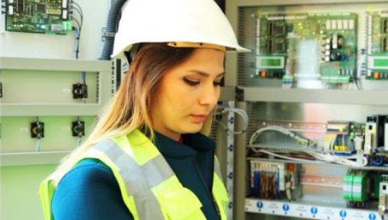 Female electrician working on an electrical panel