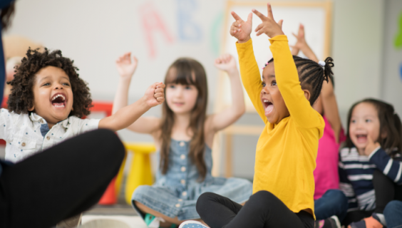 preschool children raising hands