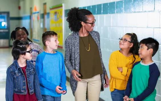 Teacher holding hands with students