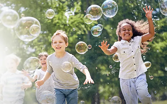 Children running with bubbles