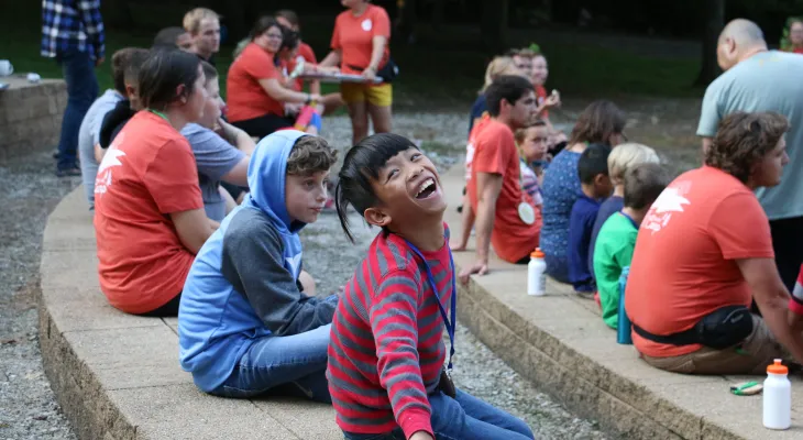Girl at SeriousFun camp smiling with other campers