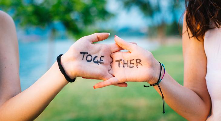 Hands with "together" written on them