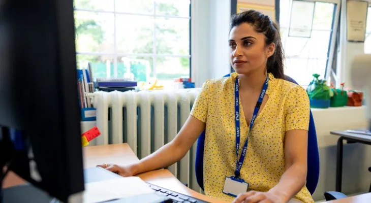 Teacher looking at computer.