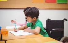 Image: Boy in wheelchair at desk