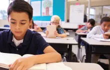 Image of young male student at a desk