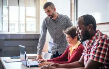 Image of adult students working on laptops