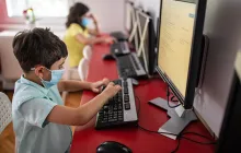 Image of students at computers with social distancing and masks