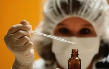 Woman scientist uses a pipette 