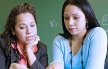 teacher and student examining a problem