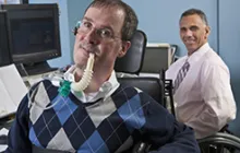 two workers with disabilities at computers