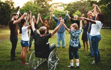Group of people outside holding hands