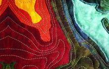 Colorful pieces of fabric stitched together to make a wavy pattern