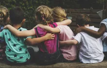 Young kids with arms around each other