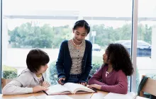 Middle school students reading together