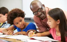 Teacher helping pupils study